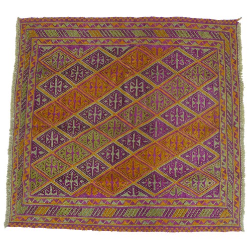 253 - A Gazak rug with purple orange and green ground, diamond patterned field, 126 by 120cm.