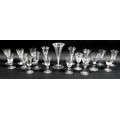 A collection of clear glass drinking glasses, mostly Victorian and later, including trumpet shaped a... 