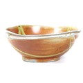 A large 20th century studio pottery bowl, of shaped circular form with orange and green glazed decor... 