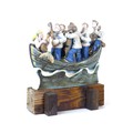 A Studio Pottery figural group, modelled as fishermen serenading a mermaid with guitars, in a boat a... 