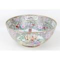 A modern Chinese Canton porcelain punch bowl, typically decorated with reserves depicting figures in... 