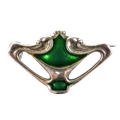 An Art Nouveau Charles Horner silver brooch, of organic pierced form, decorated with green enamel, p... 
