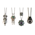 A group of four white metal Art Nouveau style and Art Deco levalier necklaces, comprising one of cir... 