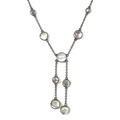 A vintage white metal and moonstone necklace, formed of nine cabochon moonstones, 7mm to 5mm, with b... 