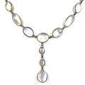 An Art Deco white metal and moonstone pendant necklace, formed of a single string of ninety variousl... 