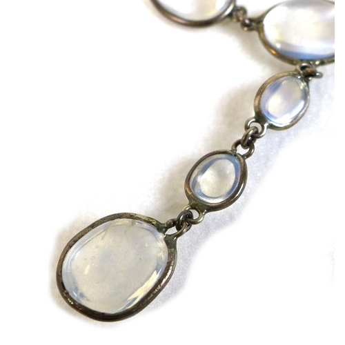 116 - An Art Deco white metal and moonstone pendant necklace, formed of a single string of ninety variousl... 