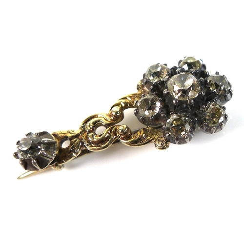 117 - An early 19th century yellow metal and diamond flowerhead brooch, central 4mm rose cut stone surroun... 