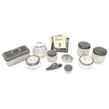 A group of silver topped dressing table items, including glass cosmetics pots, tallest 6cm high, rec... 