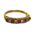 A 9ct gold, diamond and ruby nine stone ring, the round cut stones alternately set in a single row, ... 