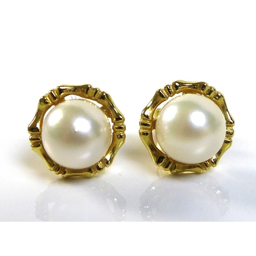 127 - A pair of Hong Kong 18ct gold and pearl stud earrings, of good white lustre, approximately 6.81mm, t... 