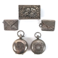 A group of Edwardian silver vertu items, comprising two sovereign holders, two stamp holders, and a ... 