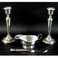 A pair of silver candlesticks, each 21cm high with weighted bases, Francis Howard, Birmingham 1974, ... 