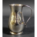 An ERII silver milk jug with planished finish, Howard Jesse Brown, London 1952, 8 by 5.5 by 9cm high... 