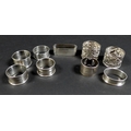 A collection of Edwardian and later silver napkin rings, including three Edwardian rings, two with p... 