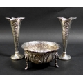 A pair of Edward VII Art Nouveau silver spill vases, with whiplash shaped rims and relief floral des... 