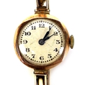 An Art Deco 9ct gold cased lady's wristwatch, circular silvered dial, black Arabic numerals, on a 9c... 