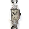 A lady's platinum and diamond set cocktail watch of Art Deco design, set with fourteen diamonds, sil... 