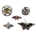 A collection of five brooches, comprising an Edwardian Scottish silver butterfly shaped brooch, deco... 