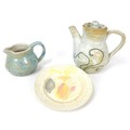 A 20th century studio pottery coffee pot, the cream on biscuit textured ground decorated with sky bl... 