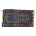 A Persian prayer rug with blue ground, green stylised arch on the purple and cream decorated field, ... 