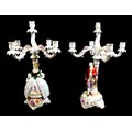 A pair of Schierholz Plaue, PMP porcelain figural candelabra, each with four scroll arms, above a Ge... 