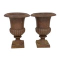 A pair of cast iron garden urns of classical campana form, with well rusted finish, the rim with rep... 