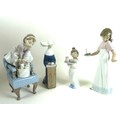 A group of two Lladro and two Nao figurines comprising Lladro: 'Purr-fect Friends', number 6512, 23.... 
