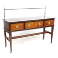 A Regency mahogany and inlaid sideboard, with brass pole upstand, three frieze drawers with oval bra... 