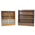 A vintage mahogany Herbert E Gibbs glazed bookcase, the two sliding glass doors enclosing two fixed ... 