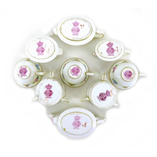 74 - A Minton miniature cabaret tea service, decorated with floral sprays against a white ground, teapot ... 