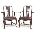 A pair of Edwardian mahogany open armchairs, drop in burgundy leather seats, out-scrolled arms, rais... 