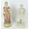 Two early 20th century figurines, comprising a standing female with head scarf, 13 by 12.5 by 38cm h... 
