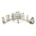 A group of eight bisque and ceramic figurines, including a 19th century Royal Berlin (KPM) factory p... 