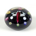 A Paul Ysart style paperweight, the black ground decorated with a butterfly with red body and white ... 