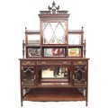 A Victorian mahogany sideboard the top with mirrored shelves flanking a central cupboard with astrag... 
