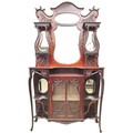 An Art Nouveau mahogany sideboard, with fluidly shaped top having two shelves to each side with ogee... 