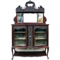 A high Victorian display sideboard cabinet, with shaped mirror back with carved crest rail above, th... 