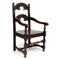 An 18th century and later oak open armchair, with two crescent shaped rails carved with face masks, ... 