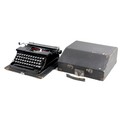 A vintage Blue Bird typewriter, with black finish, serial 302730, in black carry case.