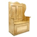 A modern pine box settle, the high shaped wing back with two panels, lift seat and single panel to f... 