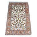 A Kashmir silk rug with cream ground, the field with floral and foliate decoration, five banded bord... 