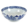 A Chinese porcelain blue and white bowl, Qing Dynasty, 18th century, the body painted with houses in... 
