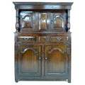 An 18th century oak court cupboard, the cornice supported on two baluster columns, two small arched ... 