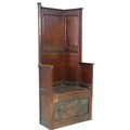 An 18th century oak porter's chair, the high six panel back over a box base, the front panel hinged ... 