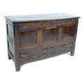 A 17th century oak mule chest, with blind carved scrolling frieze and three panel front, above two d... 