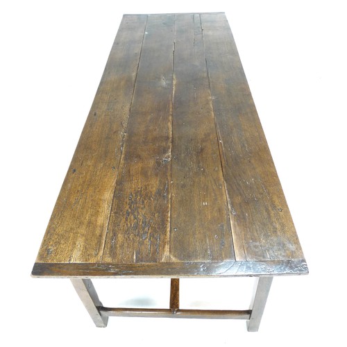 378 - A 18th century oak refectory table, the four plank surface with breadboard ends over a plain frame w... 