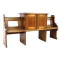 An unusual Victorian oak pew, with open back and shaped ends, fitted to its centre with a raised two... 