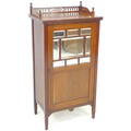 An Edwardian mahogany music cabinet, with pierced gallery, the door with nine inset bevelled mirror ... 