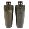 A mirrored pair of Japanese Meiji period bronze vases, of shouldered tapering cylindrical form, inla... 