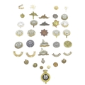 A collection of thirty-five Lincolnshire and Northampton regimental badges, including a Grantham Sch... 